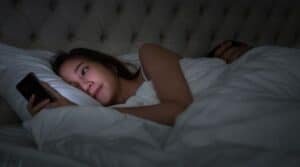 Women phone in bed